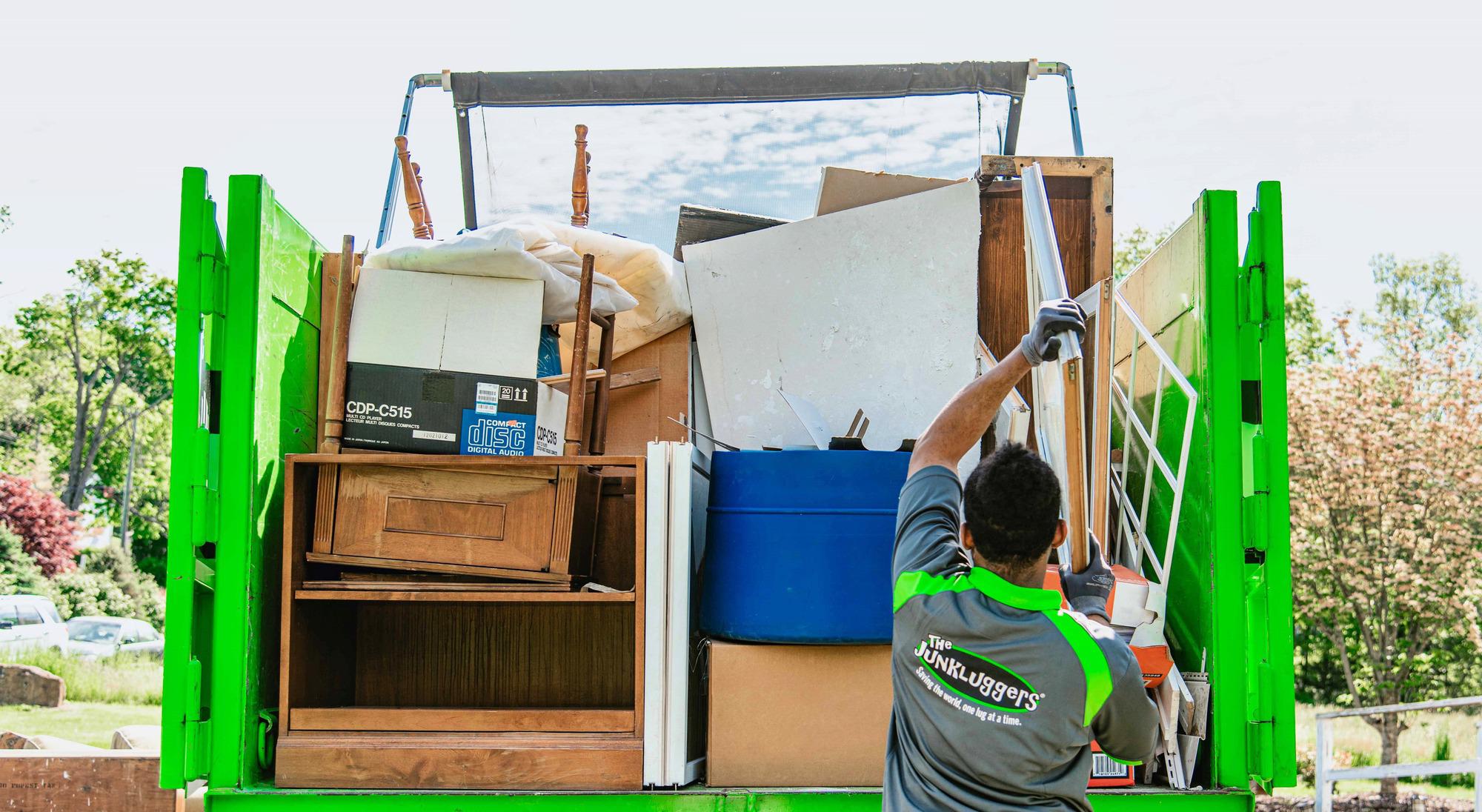 Junkluggers team member loading junk into truck